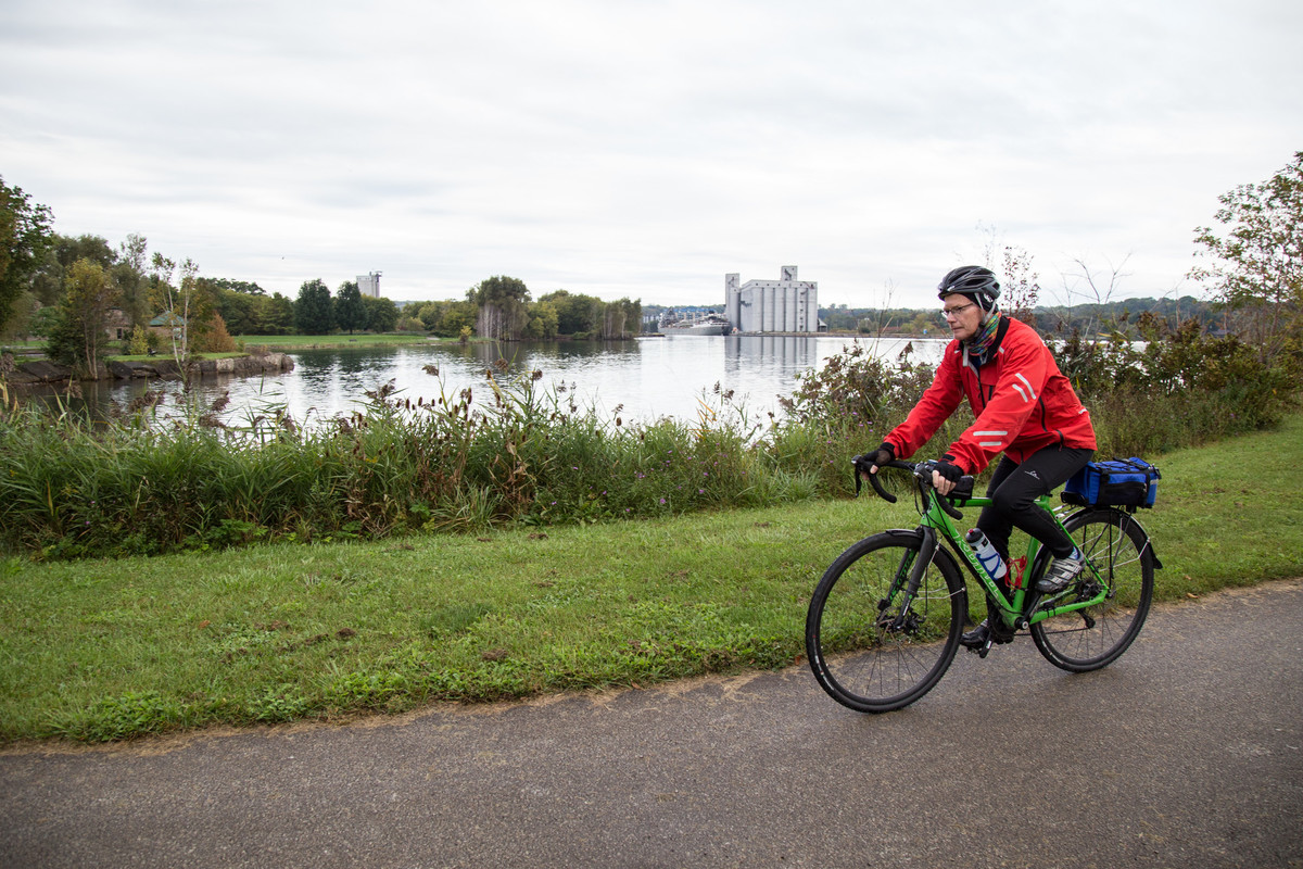 Cyclist cycling along the waterfront and grain elevators in Owen Sound