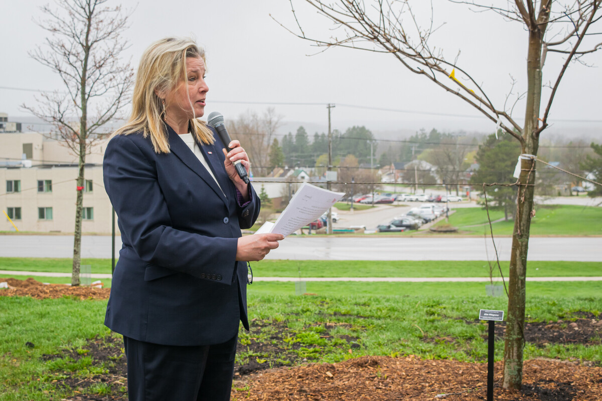 Grey County Warden Andrea Matrosovs giving remarks outside in front of tree being dedicated to former CAO Kim Wingrove