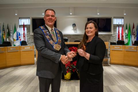 Grey County Warden Brian Milne accepts his gavel from Tara Warder, Clerk