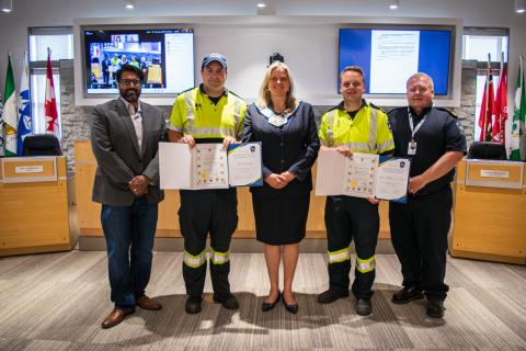 Paramedic Todd Neerhof and Reid Milne-O’Neil receive awards from Dr. Sunil Mehta, Grey County Warden Andrea Matrosovs, and Paramedic Chief Kevin McNab. 