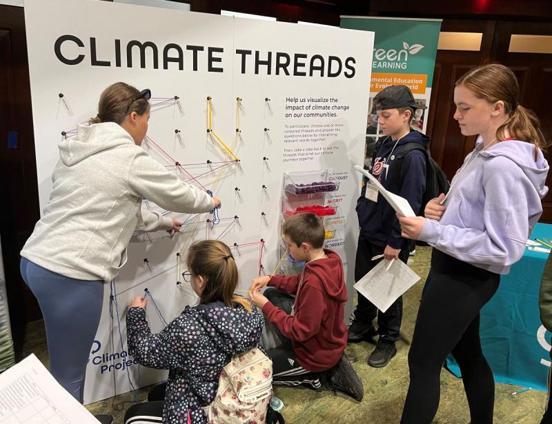 students engaging with climate threads interactive activity board