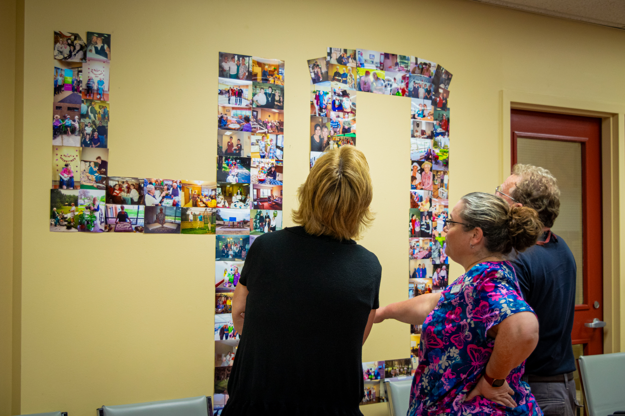 Display of pictures and newspaper clippings of residents, resident family members, and events from years past in the shape of a 40