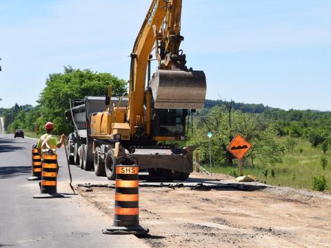 excavator smoothes the land.