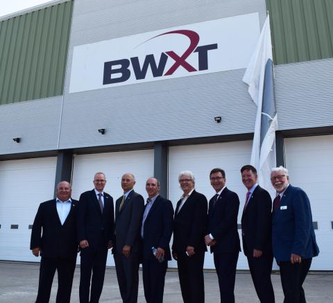 Warden Halliday stands beside Mayor Boddy and officials from Bruce Power, BWXT and Brotech in front of the former PPG building.