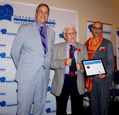 Gilbert Rice receives a framed certificate to recognize his OMA Volunteer Award 