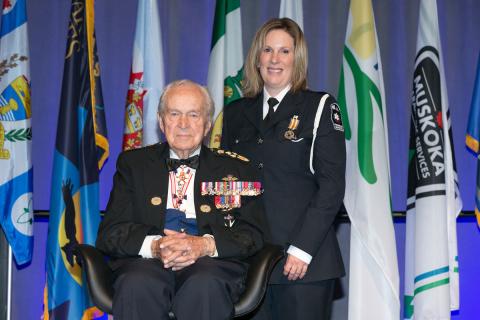 Jodi MacInnis stands next to Honorary Lieutenant-General Richard Rohmer