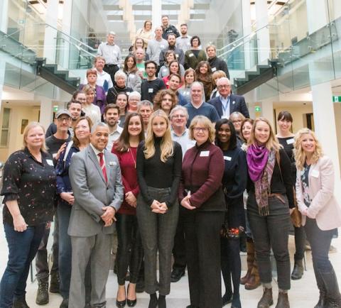 Attendees of the Let's Talk Tourism event pose on the staircase.