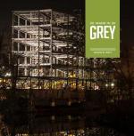 Cover of the Made in Grey magazine showing the beams of a new condominium lit up in the night sky above downtown owen sound.