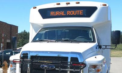 image of a small buss with a front sign that reads "Rural Route"