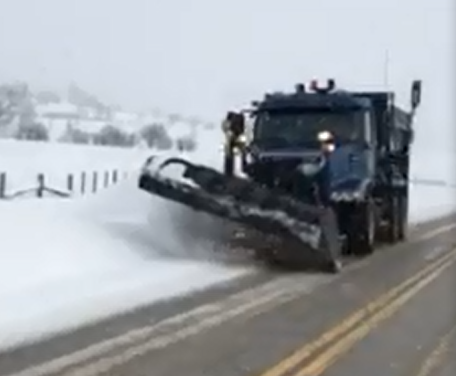 Plow moving snow