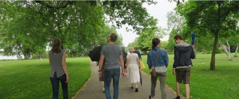 People walk down a path in the park.