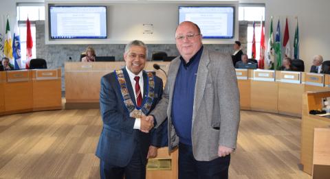 Warden Selwyn Hicks shakes hands with Town of the Blue Mountains alternate councillor Rob Potter