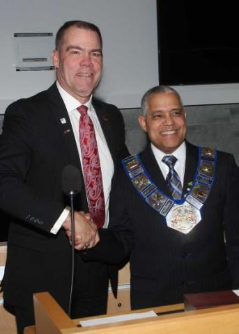 Brian Milne, past warden and current Grey County Councillor, presents Selwyn "Buck" Hicks with the Chain of office.