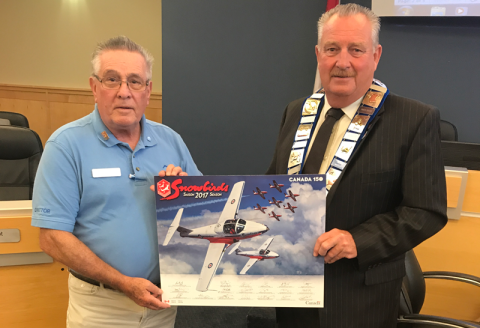 Philip Englishman presents a lithograph of the Snowbirds to Warden Alan Barfoot