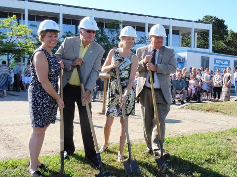 Kim Wingrove, Dwight Burley, Anne Marie Shaw and Grey County Warden Barfoot use shovels to take the first scoops of soil in front of the administration building.