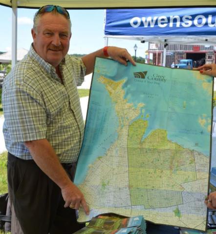 Warden Alan Barfoot shows a sneak peek of the 2017-2018 Grey County Official Map.