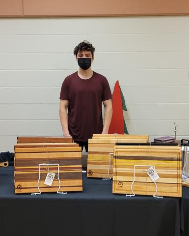 Jack Diaz, past  Summer Company participant poses with woodworking from his business Jax Woodworks