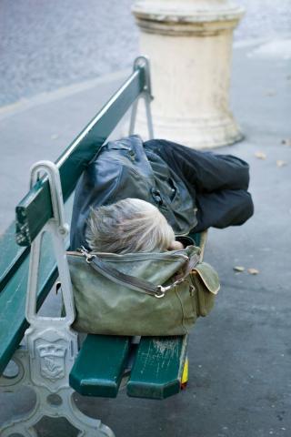 Person sleeping on bench