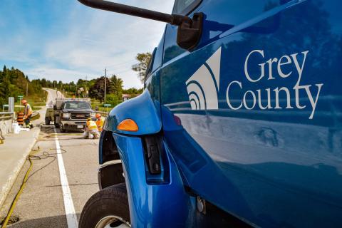 transportation vehicle close up with construction crew in background