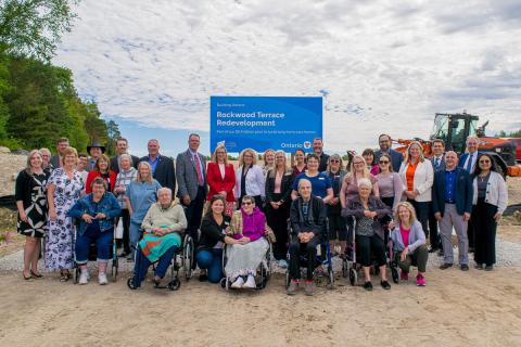 Dignitaries, councillors, residents, staff and guests pose at the Rockwood Terrace construction site in Durham during a construction ceremony.